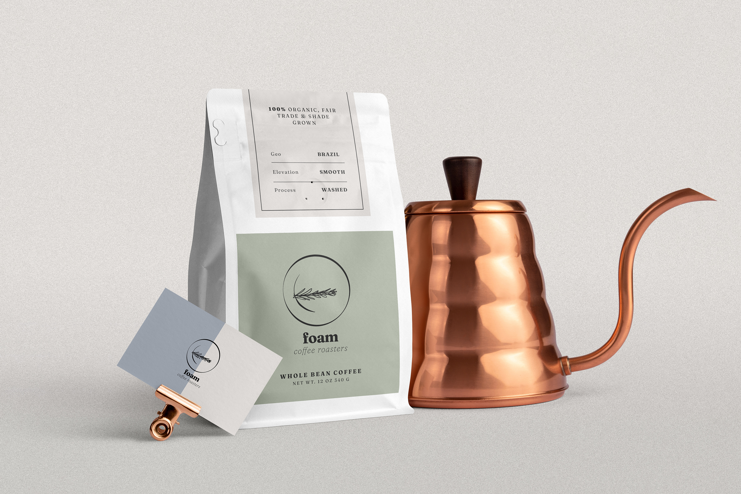 A Foam coffee bag surrounded by a Foam business card and a rose gold pour-over coffee kettle
