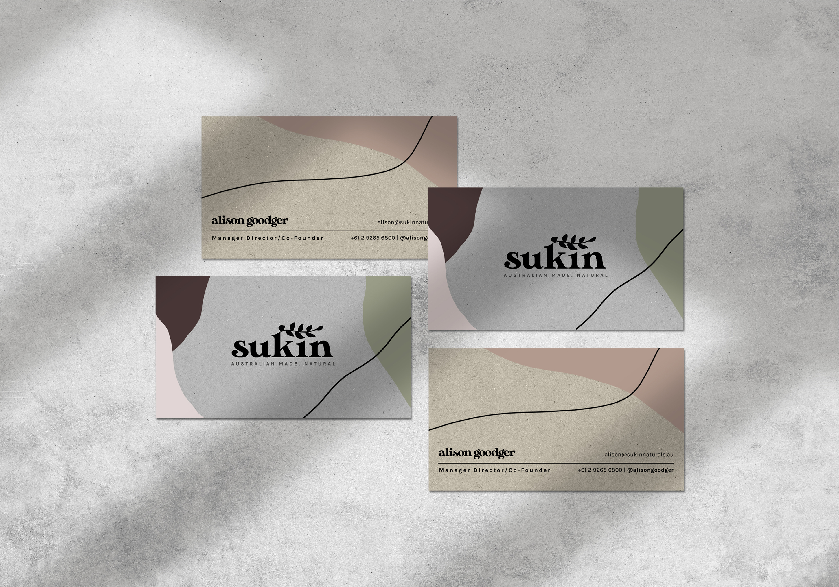 The front and back of a Sukin business card